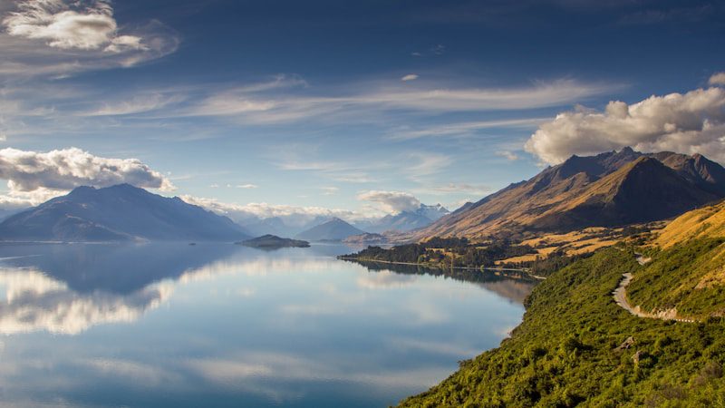 Calm blue water and mountains near Glenorchy on the Lake Wakatipu road